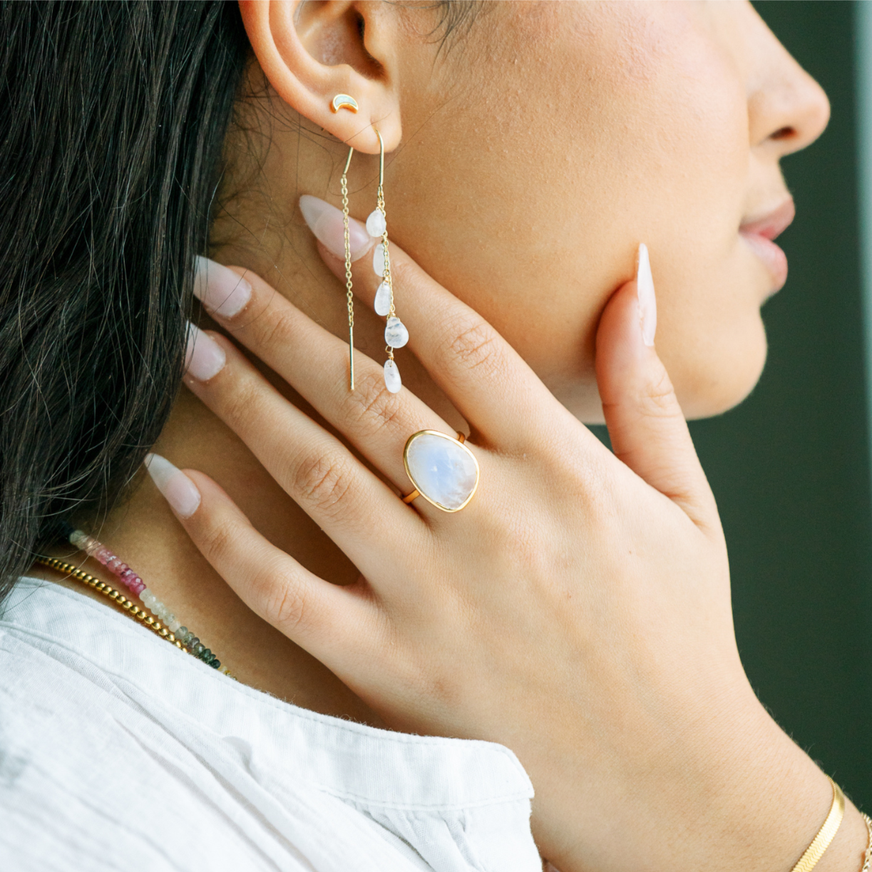 Gorgeous moonstone earrings dangle cascading drops of moonstone on a woman 