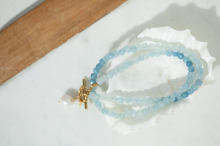 The Ombre Aquamarine Necklace with faceted cube aquamarine beads in soft,