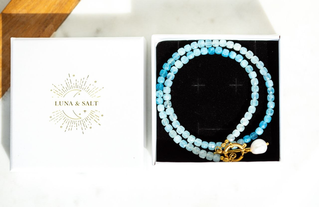 The Ombre Aquamarine Necklace with faceted cube aquamarine beads in soft,