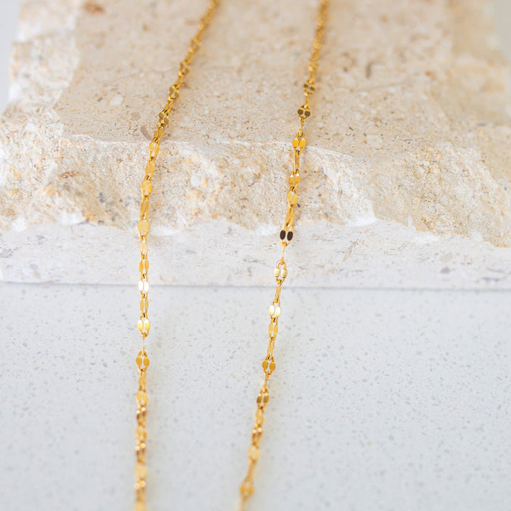 close up of a shiny gold chain necklace 