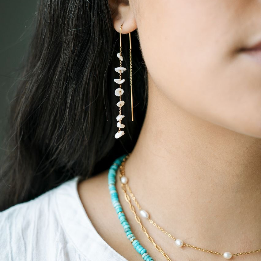 Baroque Pearl Threader Dangle Earrings on a model wearing a turquoise necklace beautiful 