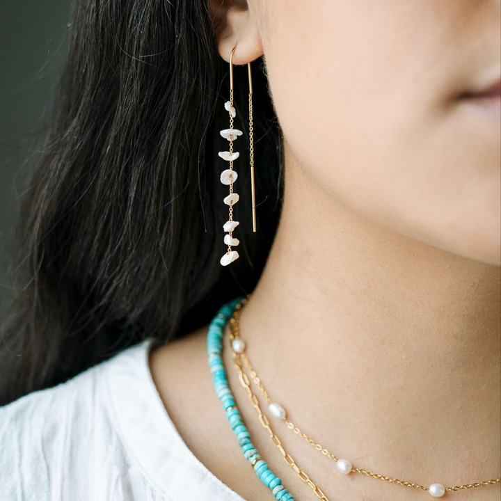 Baroque Pearl Threader Dangle Earrings on a model wearing a turquoise necklace beautiful 