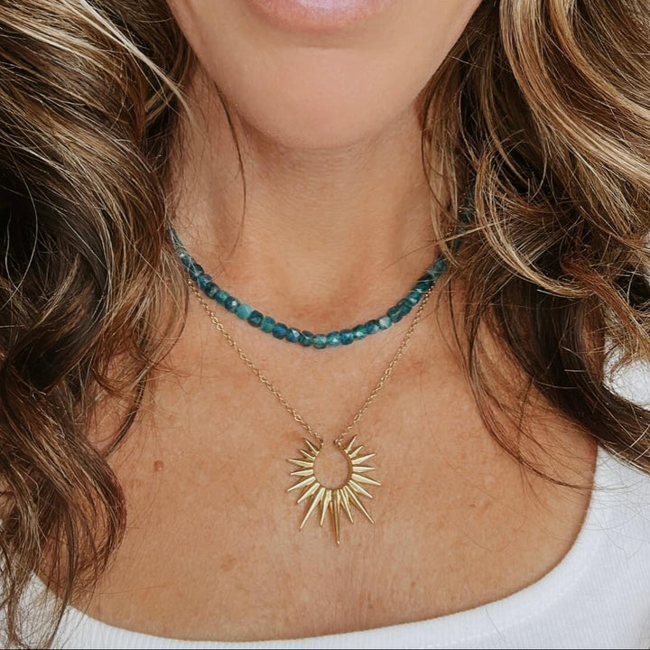 Model Wearing apatite beaded necklace with pearl pendant waterproof gold toggle necklace beach jewelry layered with a sun pendant necklace 