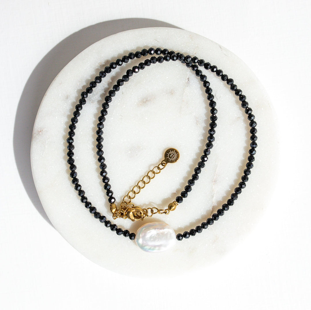 Baroque pearl necklace styled with everyday gold jewelry