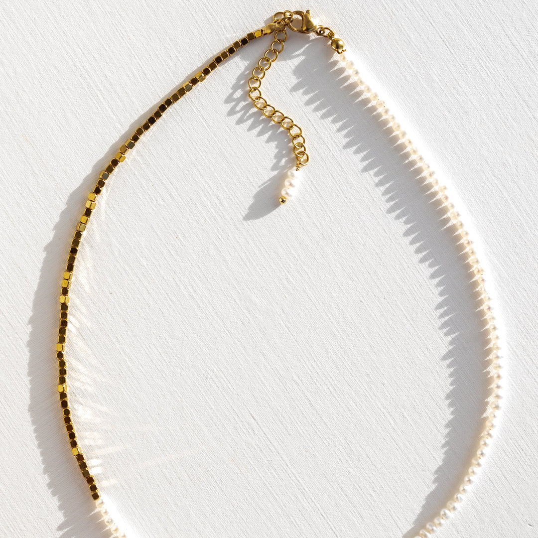 Close up of tiny baroque pearl beads and gold sparkle beads on beaded necklace