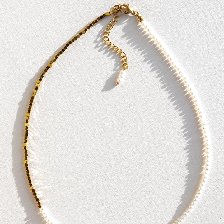 Close up of tiny baroque pearl beads and gold sparkle beads on beaded necklace