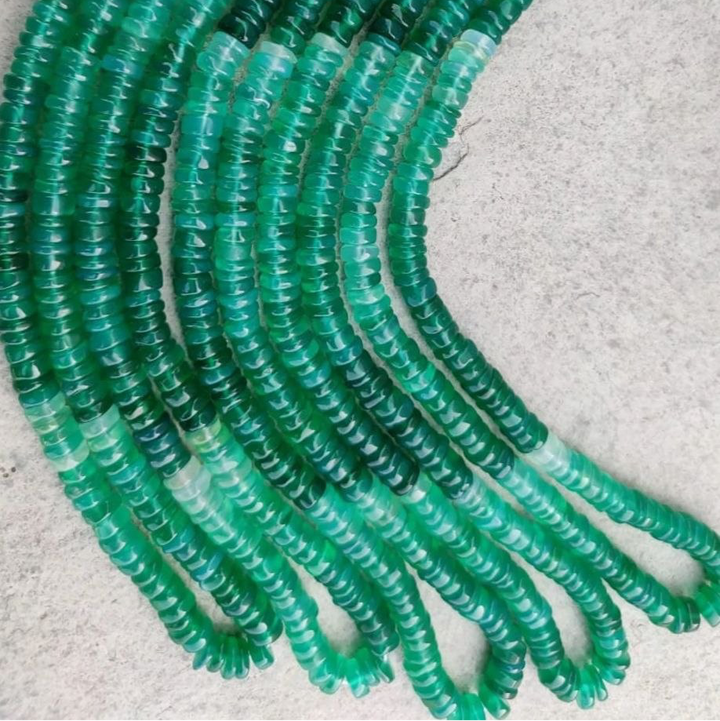 several ombre green onyx necklaces on backdrop 