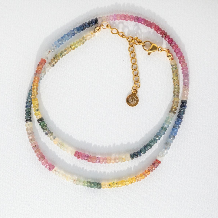 Multicolored beaded necklace with a gold clasp on a white background