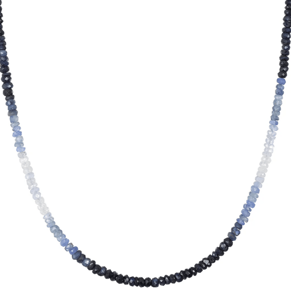 Necklace with blue and black beaded strands on a white background