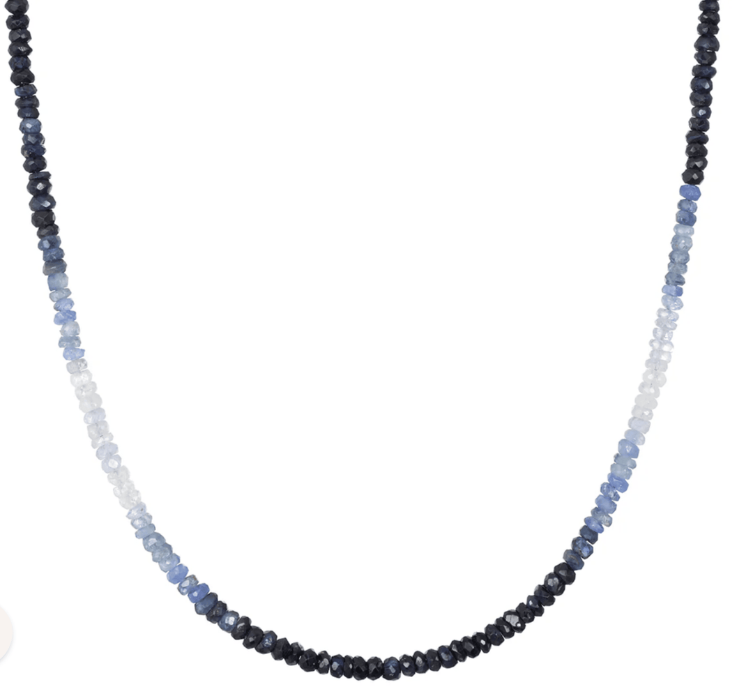 Necklace with blue and black beaded strands on a white background