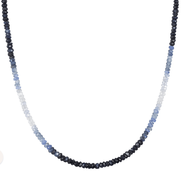 Necklace with blue and black beaded strands on a white background