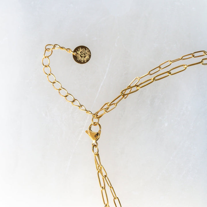 Gold waterproof necklace stacked layered sun jewelry styled with outfit inspiration