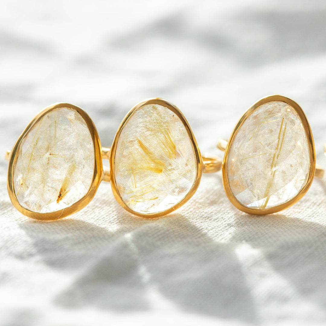 Golden rutilated quartz ring close up showing rutile needle inclusions gold vermeil setting