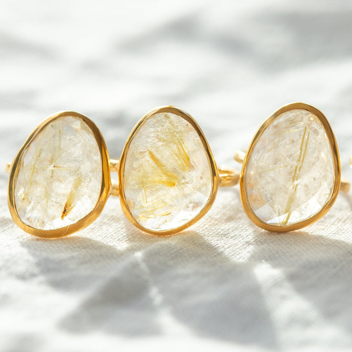 Golden rutilated quartz ring close up showing rutile needle inclusions gold vermeil setting