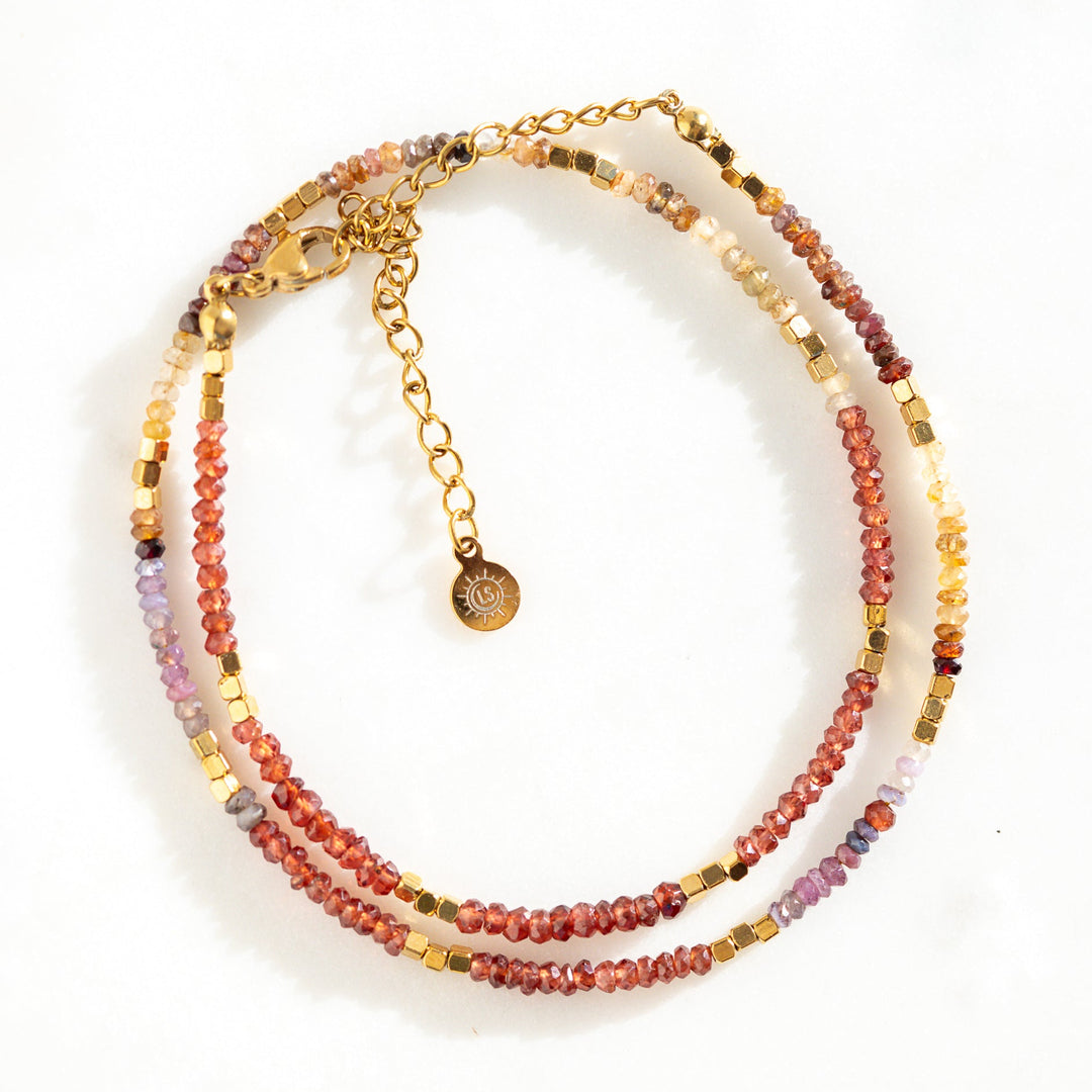 Waterproof gold bead necklace with genuine tundra sapphires in reds, oranges and purples