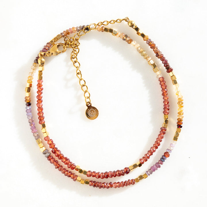 Waterproof gold bead necklace with genuine tundra sapphires in reds, oranges and purples