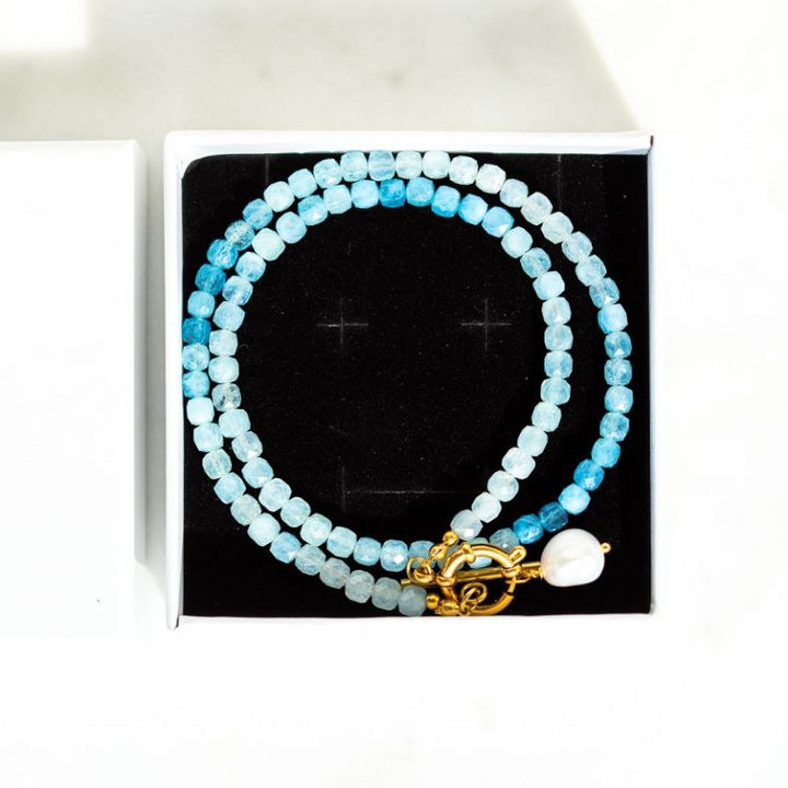 The Ombre Aquamarine Necklace with faceted cube aquamarine beads in soft ombre tones of blue 
