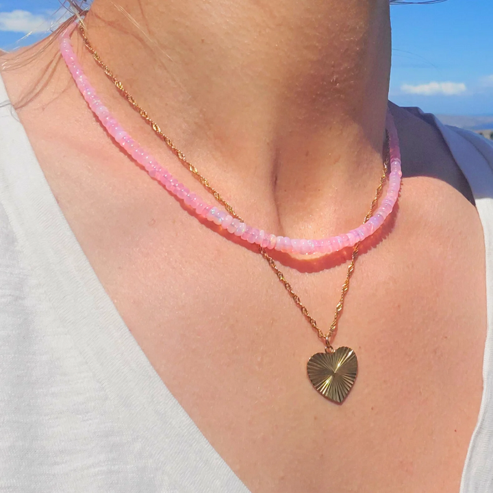close up opal necklace showing iridescent fire faceted pink opal beads gold jewelry