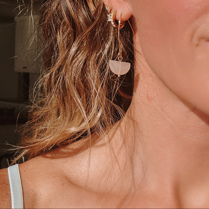 faceted peach moonstone dangle earrings close up — healing crystal jewelry for intuition and new beginnings