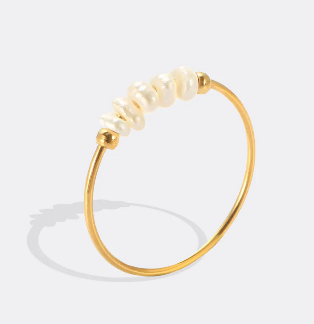 Gold ring with pearls on a white background