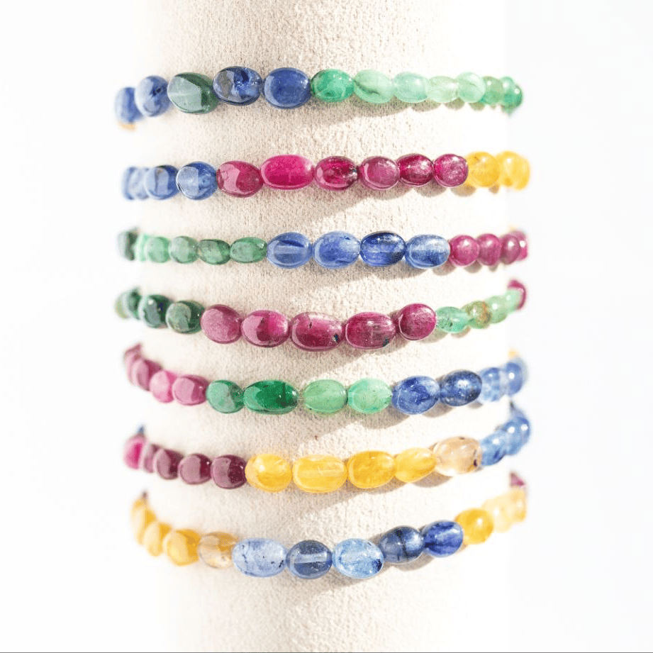 Set of colorful beaded bracelets on a white background