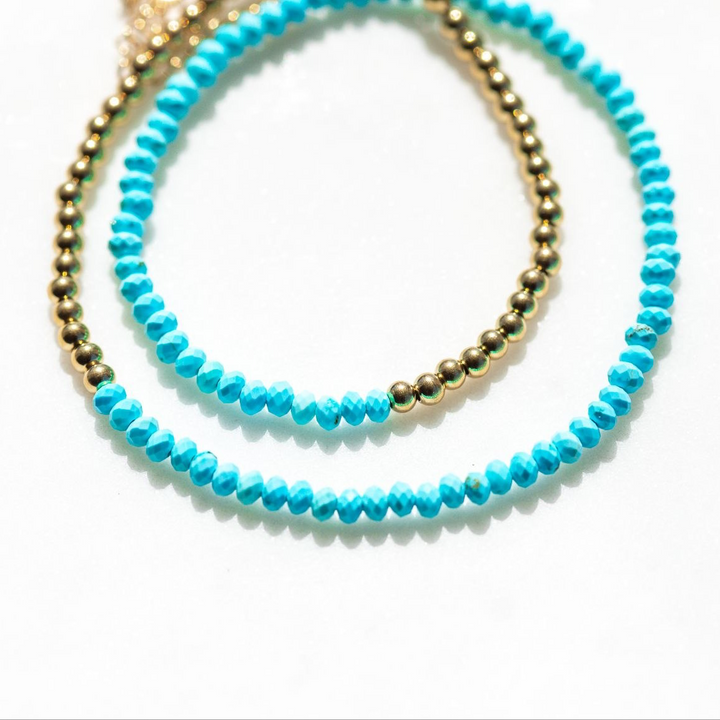 Two turquoise beaded bracelets on a white background