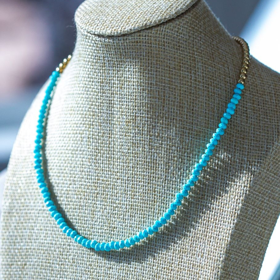 Turquoise beaded necklace on a mannequin bust