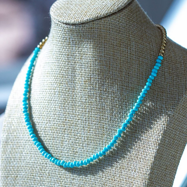 Turquoise beaded necklace on a mannequin bust