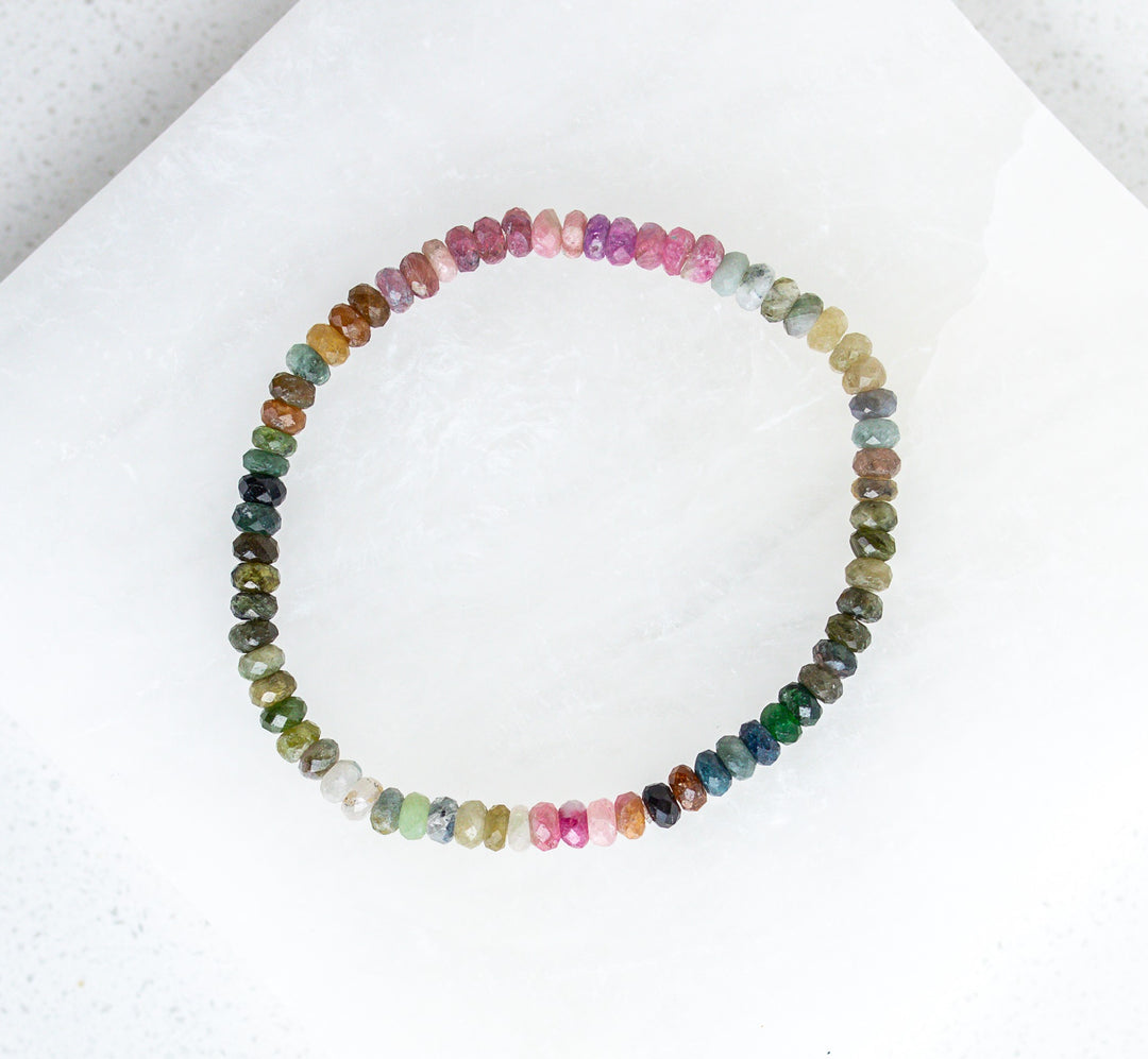 Multicolored earthy tourmaline beaded necklace on a white background