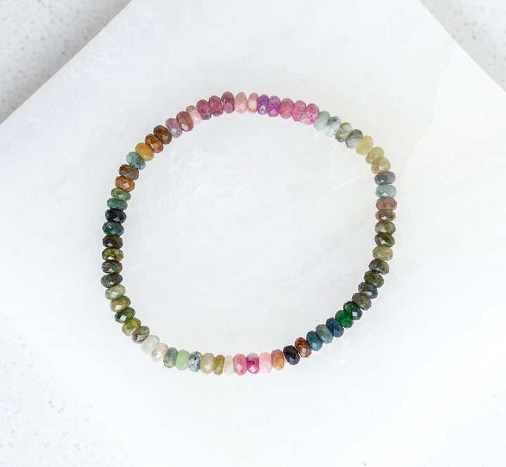 Multicolored earthy tourmaline beaded necklace on a white background
